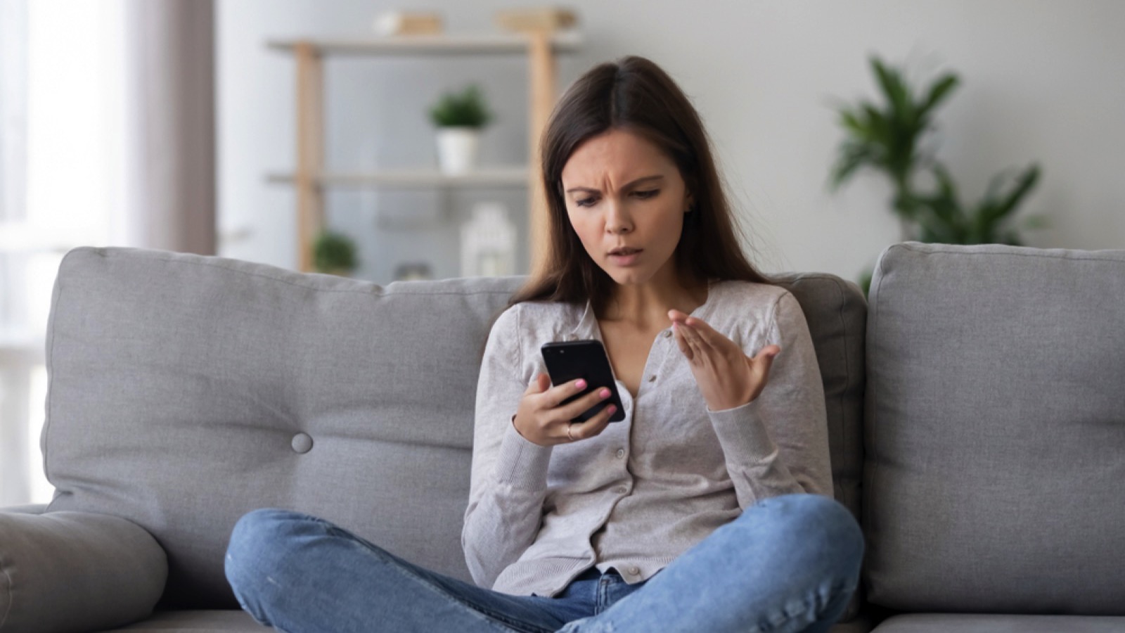 Irritated young woman with mobile